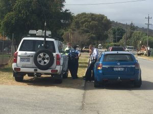 Police gather at the scene. Photograph - Amy Blom.