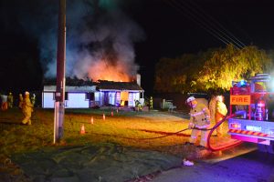 Flames leaped from the roof as firefighters attempted to bring the blaze under control. Photograph Michael J Ryan. 