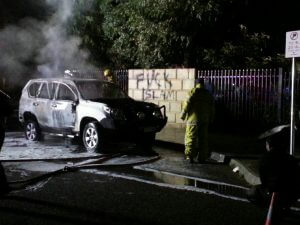 The damaged car outside the mosque.