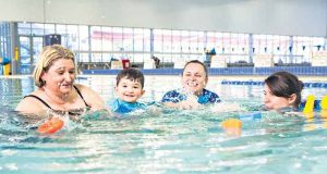 Kelly Sanders and son Jeremy benefit from swim teachers Martina McGovern and Chloe Were-Spice, who have received state recognition for their teaching. Photograph — Matt Devlin.