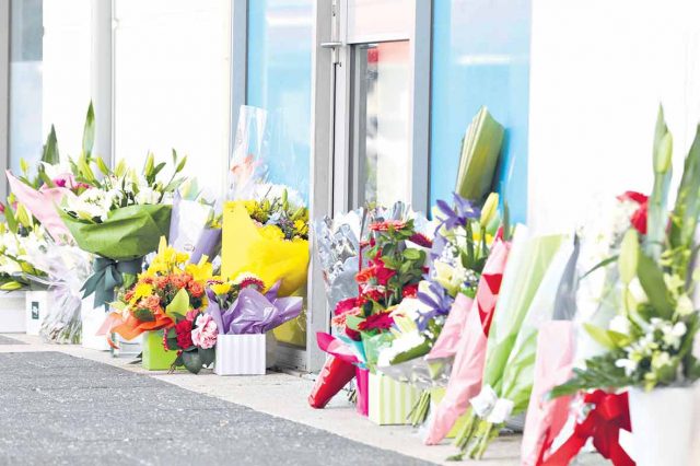 Flowers were left outside Mr Randall’s Kelmscott office yesterday. Photograph — Matt Devlin.