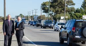 Cockburn mayor Logan Howlett and Armadale mayor Henry Zelones at the Nicholson Road intersection with traffic banking up 800 metres either side of Armadale Road. Photograph — Matt Devlin.