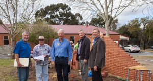 Kenwick rotary club president Ron Mildenhall, project coordinator Steve Weychan, Amaroo care services property and assets manager John Hansen, Gosnells men’s shed chairman Geoff Wiltshire and Gosnells RSL president Stuart Holmes joined forces to help build a commemorative wall, which was still under construction. Photograph — Matt Devlin.