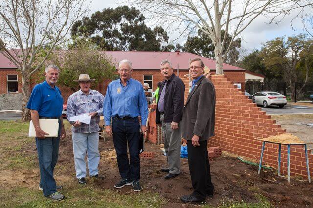 Kenwick rotary club president Ron Mildenhall, project coordinator Steve Weychan, Amaroo care services property and assets manager John Hansen, Gosnells men’s shed chairman Geoff Wiltshire and Gosnells RSL president Stuart Holmes joined forces to help build a commemorative wall, which was still under construction. Photograph — Matt Devlin.