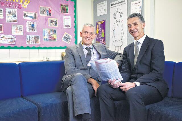 Westfield Park primary school principal Steve Soames reading the full service schools plan with Member for Armadale Tony Buti. Photograph — Matt Devlin.