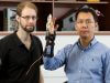 Otto Seyfarth and Lei Cui from Curtin university with the finger exoskeleton. Photograph — Matt Devlin.