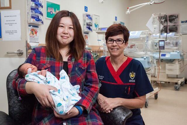 Hitomi Ogaya with 10-day old son Leon Ng and clinical nurse Leanne Howell. Leon was born five weeks early, weighing in at 2050 grams and was 40 grams heavier 10 days later. Photograph — Matt Devlin.