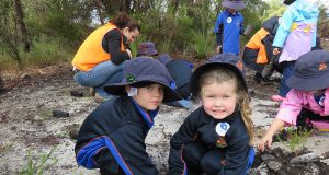 Campbell primary school kindergarten students James Lee and Holly Carter learn about the importance of tree planting.