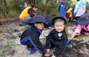 Campbell primary school kindergarten students James Lee and Holly Carter learn about the importance of tree planting.