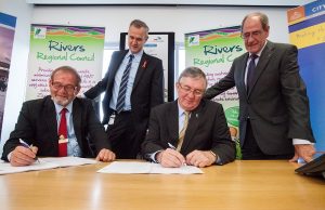 Local Government Minister Tony Simpson and Rivers Regional council chief executive Alex Sheridan witness City of Gosnells mayor Dave Griffiths and Rivers Regional council chairman Ron Hoffman signing the contracts for the alternative waste treatment facility. Photograph — Matt Devlin.