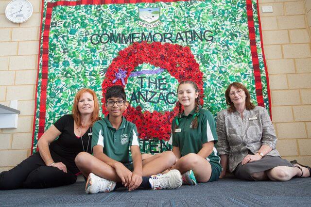 Art teacher Merranie Beal with headboy Akshay Sundru, headgirl Paris Scoby-Smith and principal Patricia Joss in front of the school’s mural. Photograph — Matt Devlin.