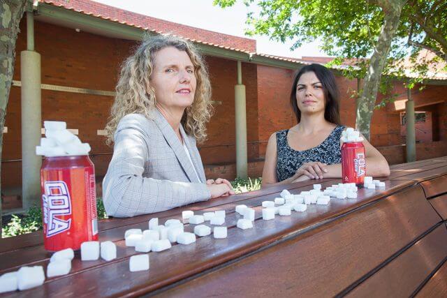 Curtin research associate Christina Pollard and live lighter campaign director Maria Szybiak were warning people about overconsumption of sugary drinks. Photograph – Matt Devlin.