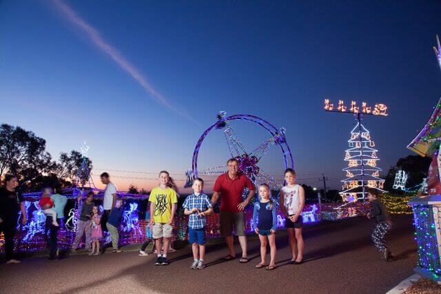 The Bailey’s grandchildren including 18-month-old Havana, eight-week-old Jordan, Emily, 9, Ella Jane, 5, Sophie, 2, Dylan, 11, and Noah, 7, enjoy the lights. Photograph – Matt Devlin.