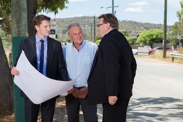 Federal Member for Canning Andrew Hastie, Shire of Serpentine Jarrahdale chief executive Richard Gorbunow and shire president John Erren inspect plans for the duplication of Abernethy Road. Photograph — Matt Devlin.