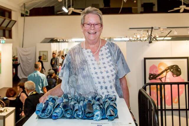 Trudi Pollard with her award winning piece Indigo Scrolls. Photograph — Kelly Pilgrim-Byrne.