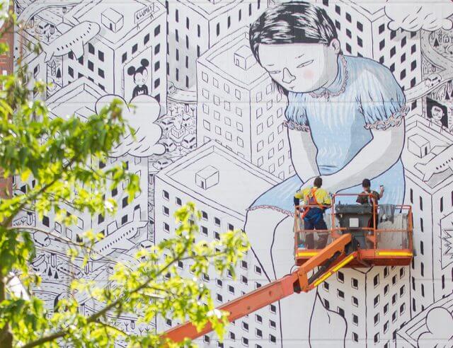 Italian street artist Millo painting a piece on the TL Robertson library at Curtin University last week. Photograph — Matt Devlin.