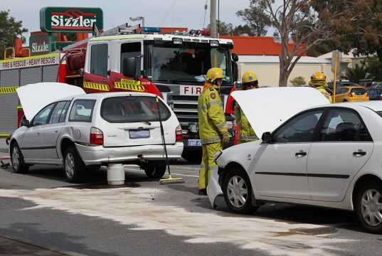 Firefighters cleaning up the fuel leak from the Falcon. Photograph – Matt Devlin.