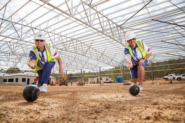 Lois Fenton and Lauris Gibb give the new green an early test run following their division three win. Photograph — Matt Devlin.