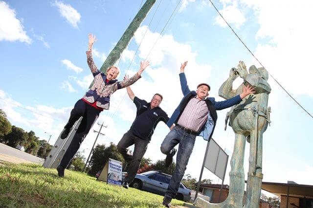 Byford Progress Association president Colleen Rankin, Shire of Serpentine Jarrahdale president John Erren and artist Len Zuks welcome traffic inspector Charlie Knox back to his old post on South Western Highway. Photograph — Matt Devlin.