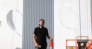 Contemporary artist Chris Nixon is painting a mural of local and migratory birds. Photograph — Matt Devlin