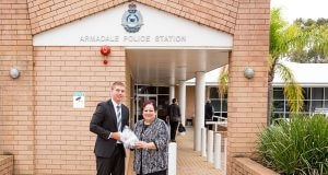 Armadale Detective First Class Constable Mike Fewster returns the medals to Angela Hartwig last week. Photograph — Kelly Pilgrim-Byrne.