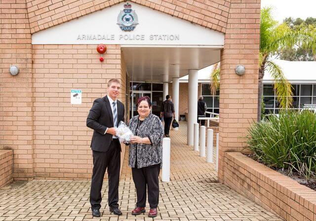 Armadale Detective First Class Constable Mike Fewster returns the medals to Angela Hartwig last week. Photograph — Kelly Pilgrim-Byrne.