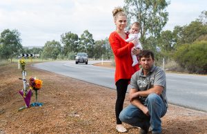 Adam, Lotti and Emilia Fairey at the S-bend outside their property, which has been the scene of three major crashes in six months. Photograph — Matt Devlin.