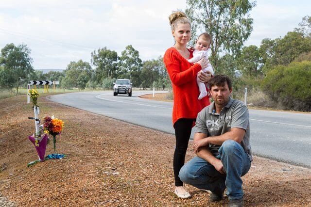Adam, Lotti and Emilia Fairey at the S-bend outside their property, which has been the scene of three major crashes in six months. Photograph — Matt Devlin.