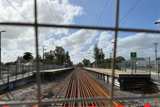 A train station behind a fence